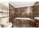 Bathroom with tiled walls, a tub, shower, and toilet at 313 Dirksen Dr # G4, Debary, FL 32713