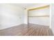 Bright, airy bedroom with neutral paint, wood laminate flooring, and closet with shelves at 313 Dirksen Dr # G4, Debary, FL 32713