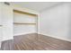 Bright bedroom features wood laminate flooring, neutral paint and a closet with shelves at 313 Dirksen Dr # G4, Debary, FL 32713