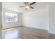A bedroom with hardwood floors and a large window for natural light at 313 Dirksen Dr # G4, Debary, FL 32713