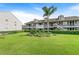 Well-maintained Riverside Condominiums features a lush green lawn, landscaping, and two-story buildings at 313 Dirksen Dr # G4, Debary, FL 32713