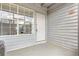 Entrance to this home featuring a white door, multi-pane window, and light-blue siding at 313 Dirksen Dr # G4, Debary, FL 32713