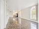 Open-concept living room with tiled floors leading to the kitchen area at 313 Dirksen Dr # G4, Debary, FL 32713