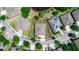 Aerial view of a single-Gathering home in a residential neighborhood, surrounded by green lawns and mature trees at 319 E Victoria Trails Blvd, Deland, FL 32724