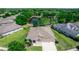 Aerial view of a single-Gathering home, showcasing the well-maintained lawn, the pond, and its proximity to the lake at 319 E Victoria Trails Blvd, Deland, FL 32724
