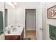 Bathroom with single sink and vanity, decorative accents, and adjacent access to other rooms at 319 E Victoria Trails Blvd, Deland, FL 32724