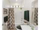 Well-lit bathroom with decorative shower curtain, coordinated towels, and unique decorative accents at 319 E Victoria Trails Blvd, Deland, FL 32724
