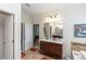 Bathroom with a single sink vanity, large mirror, and tile flooring, plus a linen closet at 319 E Victoria Trails Blvd, Deland, FL 32724