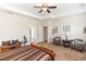 Primary bedroom features neutral paint, ceiling fan, and plush carpet at 319 E Victoria Trails Blvd, Deland, FL 32724