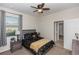 Cozy bedroom with a ceiling fan, window, and ensuite bathroom access at 319 E Victoria Trails Blvd, Deland, FL 32724