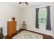 Well-lit bedroom with hardwood flooring, area rug, cabinet, and a window with curtains at 319 E Victoria Trails Blvd, Deland, FL 32724