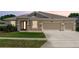 Charming single-story home with a three-car garage and stone accents at 319 E Victoria Trails Blvd, Deland, FL 32724