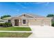Charming single-story home with a two-car garage, manicured lawn, and inviting entrance at 319 E Victoria Trails Blvd, Deland, FL 32724