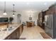 Spacious kitchen featuring dark wood cabinetry, granite counters, and stainless steel appliances at 319 E Victoria Trails Blvd, Deland, FL 32724