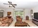 Spacious living room featuring tile flooring, ceiling fan, and outdoor access at 319 E Victoria Trails Blvd, Deland, FL 32724