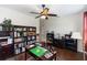 Office featuring a desk, hardwood floors, a ceiling fan and built in bookshelves at 319 E Victoria Trails Blvd, Deland, FL 32724