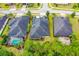 An aerial shot showing the home's rooftop, backyard, and surrounding trees and neighborhood at 341 Chelsea Place Ave, Ormond Beach, FL 32174