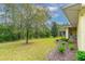Expansive backyard features mature trees, lush lawn, and a screened patio at 341 Chelsea Place Ave, Ormond Beach, FL 32174