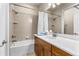 Bright bathroom featuring a tub with shower, vanity with storage, and neutral color scheme at 341 Chelsea Place Ave, Ormond Beach, FL 32174
