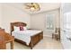 Cozy bedroom with tile flooring, a ceiling fan, shuttered window and neutral paint at 341 Chelsea Place Ave, Ormond Beach, FL 32174