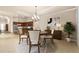 Dining area showcases modern chandelier, complementing kitchen and living space at 341 Chelsea Place Ave, Ormond Beach, FL 32174