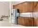 Well-lit kitchen features stainless steel appliances, wooden cabinetry, and light tile backsplash at 341 Chelsea Place Ave, Ormond Beach, FL 32174