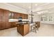 A modern kitchen with wooden cabinets, stainless steel appliances, and a kitchen island at 341 Chelsea Place Ave, Ormond Beach, FL 32174