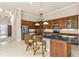 A modern kitchen with granite countertops, stainless steel appliances, and wooden cabinets at 341 Chelsea Place Ave, Ormond Beach, FL 32174