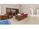 An elegant living room with tile floors, leather couches, and a wooden entertainment center at 341 Chelsea Place Ave, Ormond Beach, FL 32174