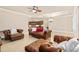 An open concept living room with leather couches and a peek into the kitchen at 341 Chelsea Place Ave, Ormond Beach, FL 32174