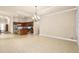 Open-concept living space flows into kitchen, features tile flooring and ample natural light at 341 Chelsea Place Ave, Ormond Beach, FL 32174