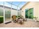 Screened patio features brick flooring and comfortable seating area for outdoor relaxation at 341 Chelsea Place Ave, Ormond Beach, FL 32174