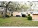 A residential backyard featuring a small shed and modest landscaping on a leafy lawn at 34416 Oak Ave, Leesburg, FL 34788