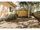 Backyard featuring a large shed, fenced perimeter, and mature trees at 34416 Oak Ave, Leesburg, FL 34788