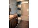 A bathroom with a toilet, vanity, and shower/tub combination with light blue walls at 34416 Oak Ave, Leesburg, FL 34788