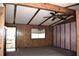 Spacious living room with wood paneling, ceiling fan, and natural light, creating a cozy atmosphere at 34416 Oak Ave, Leesburg, FL 34788