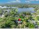 Stunning aerial view of lakeside estate featuring lush landscaping, private pool, and serene water views at 349 Evansdale Rd, Lake Mary, FL 32746