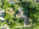 Aerial view of a home surrounded by lush trees, a pool and a long stone driveway at 349 Evansdale Rd, Lake Mary, FL 32746