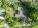 Aerial view of a home surrounded by lush trees, a pool and a long stone driveway at 349 Evansdale Rd, Lake Mary, FL 32746
