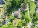 Aerial view of a home with a large yard, swimming pool and long driveway at 349 Evansdale Rd, Lake Mary, FL 32746