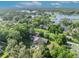 Scenic aerial perspective of a private residence by a lake, complete with a pool and green surroundings at 349 Evansdale Rd, Lake Mary, FL 32746