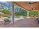 Covered porch with ceiling fans overlooking a kidney-shaped pool with brick patio at 349 Evansdale Rd, Lake Mary, FL 32746