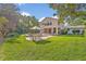 Spacious backyard with lush green lawn, swimming pool, and an outdoor table and chair set at 349 Evansdale Rd, Lake Mary, FL 32746