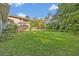 Spacious backyard with lush green lawn, wooden privacy fence, patio and an in-ground pool at 349 Evansdale Rd, Lake Mary, FL 32746