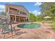 Backyard with swimming pool, brick pavers, covered patio, second story balcony, chairs and dining table at 349 Evansdale Rd, Lake Mary, FL 32746