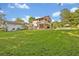 Large backyard with a pool, outdoor seating, second story balcony and lush lawn at 349 Evansdale Rd, Lake Mary, FL 32746