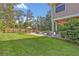 Large backyard with in-ground pool, covered patio, and wooden privacy fence at 349 Evansdale Rd, Lake Mary, FL 32746