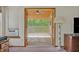 View through doors to balcony, with ceiling fan and open view to the yard at 349 Evansdale Rd, Lake Mary, FL 32746