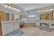 Elegant bathroom features dual vanities, a soaking tub, and tile flooring at 349 Evansdale Rd, Lake Mary, FL 32746