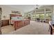 Large bedroom with a desk area, ceiling fan, and multiple windows providing ample natural light at 349 Evansdale Rd, Lake Mary, FL 32746